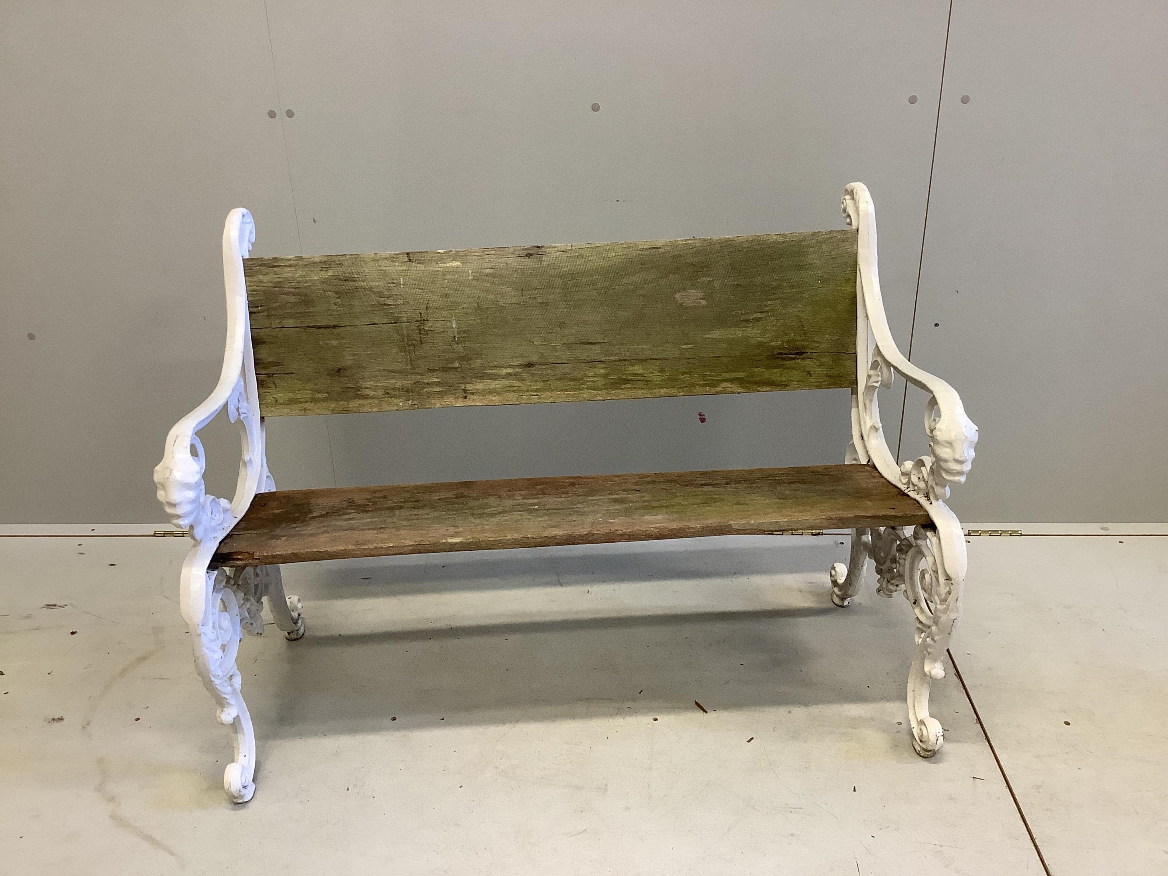 A Victorian cast iron and planked wood garden bench, width 113cm. Condition - fair